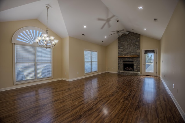 unfurnished living room with baseboards, ceiling fan with notable chandelier, a fireplace, high vaulted ceiling, and dark wood-style flooring