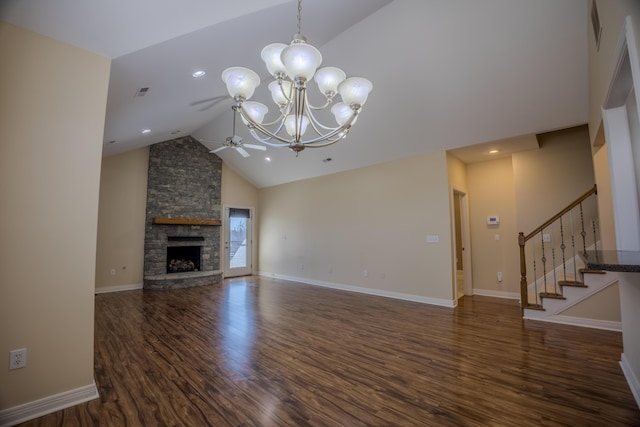 unfurnished living room with stairway, wood finished floors, baseboards, high vaulted ceiling, and a stone fireplace