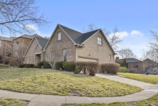 view of side of home with concrete driveway, a yard, brick siding, and a garage