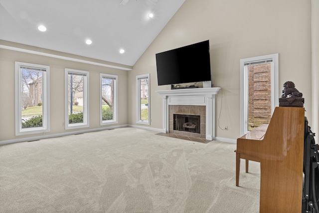 unfurnished living room with high vaulted ceiling, recessed lighting, carpet, a fireplace, and baseboards