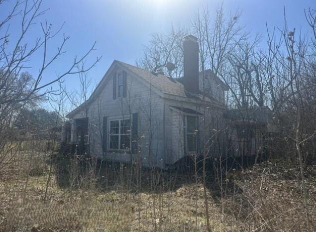 view of property exterior with a chimney