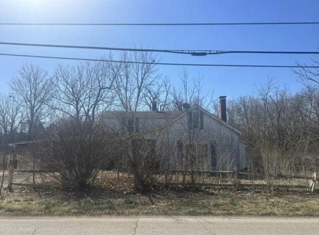 view of side of home featuring fence