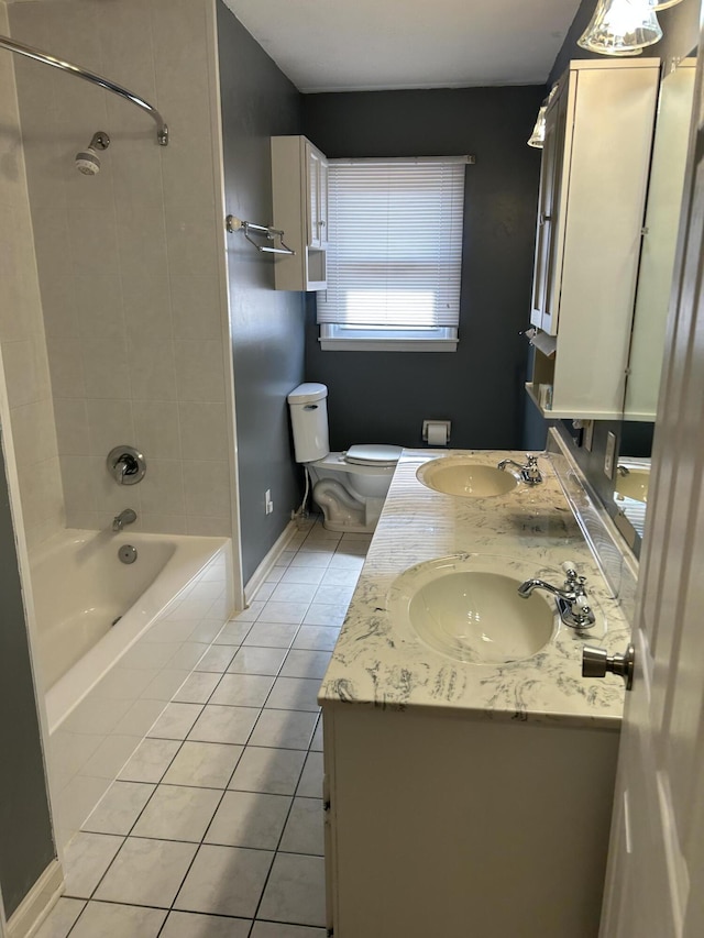 bathroom with tile patterned flooring, shower / bathing tub combination, double vanity, and a sink