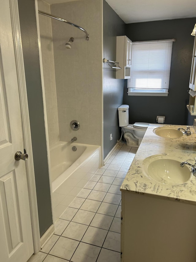 bathroom featuring a sink, double vanity, bathtub / shower combination, and tile patterned floors