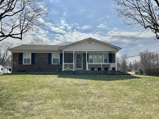 view of front of property with brick siding, a porch, and a front lawn