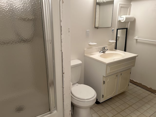 full bathroom featuring vanity, toilet, a shower stall, and tile patterned flooring