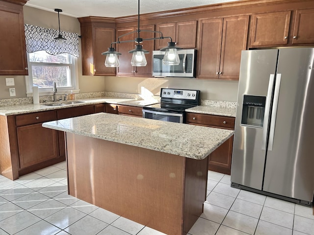 kitchen featuring light tile patterned flooring, a sink, stainless steel appliances, decorative light fixtures, and a center island