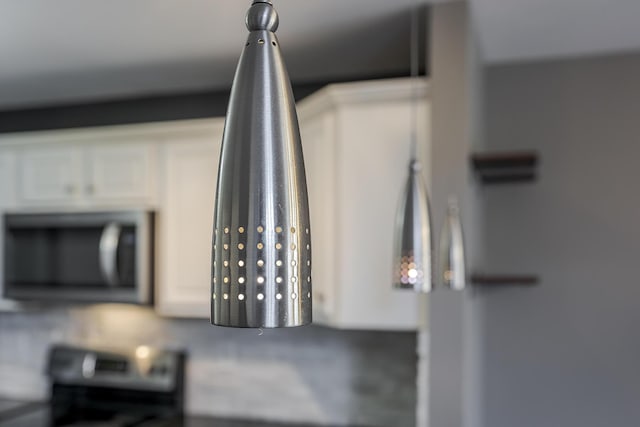 room details with stainless steel appliances and white cabinets