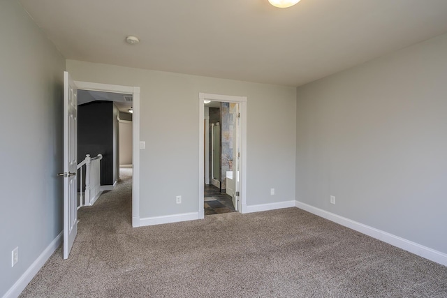 unfurnished bedroom with carpet flooring and baseboards