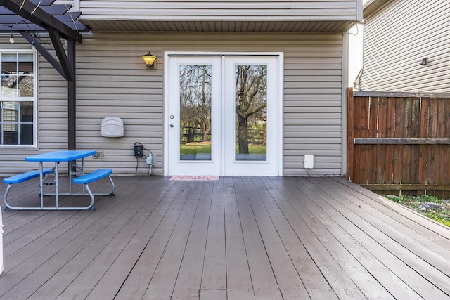 deck featuring fence and a pergola