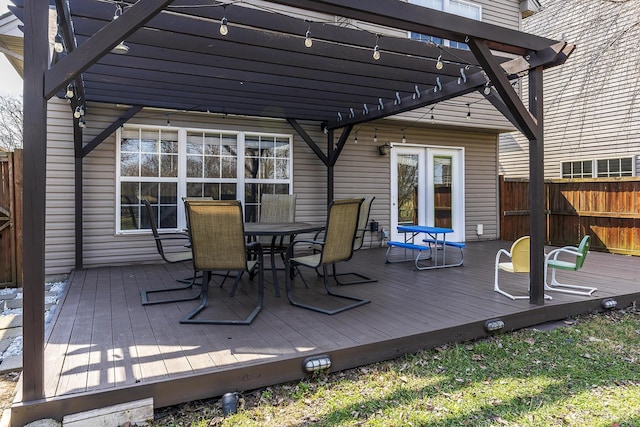 deck featuring outdoor dining area, fence, and a pergola