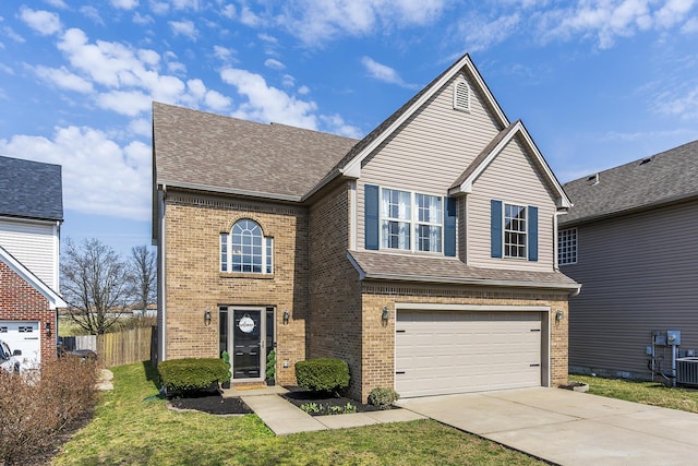 traditional-style house with brick siding, concrete driveway, an attached garage, and a shingled roof