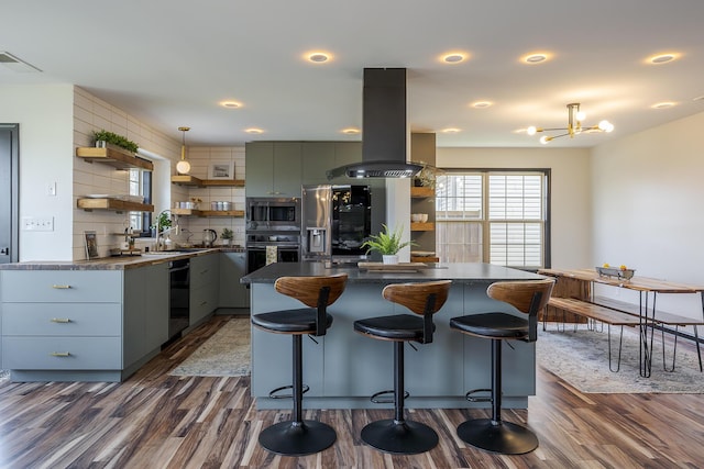 kitchen featuring dark countertops, a center island, island range hood, black appliances, and open shelves