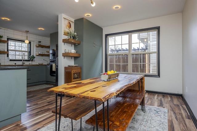 dining area with baseboards and dark wood-style flooring