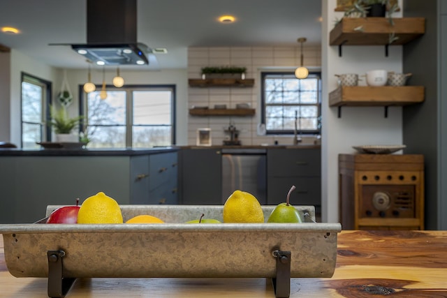 kitchen featuring a wealth of natural light, dishwashing machine, open shelves, and island range hood