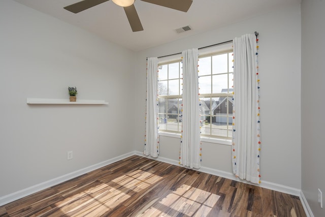 doorway to outside featuring visible vents, baseboards, wood finished floors, and a ceiling fan