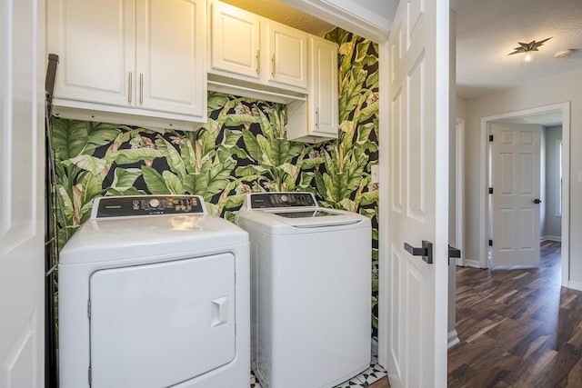 laundry area featuring wallpapered walls, baseboards, cabinet space, and washer and clothes dryer