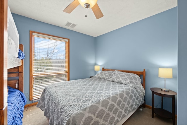 bedroom featuring visible vents, baseboards, carpet, and ceiling fan