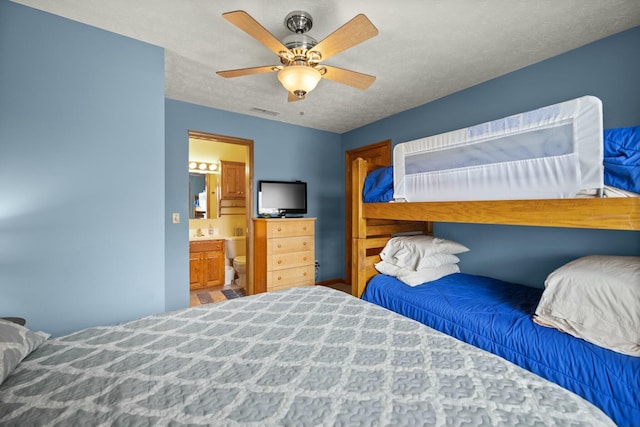 bedroom featuring visible vents, a textured ceiling, ensuite bathroom, and ceiling fan