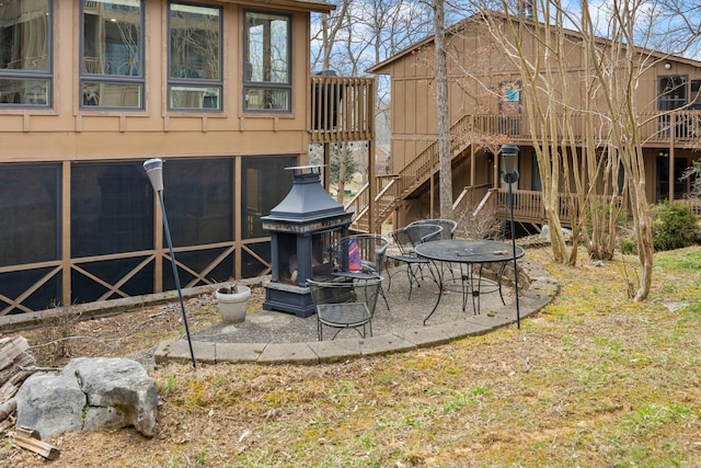 back of property featuring stairway and a patio area