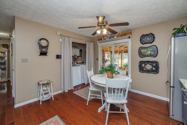 dining area featuring dark wood-style floors, washing machine and dryer, baseboards, and a ceiling fan