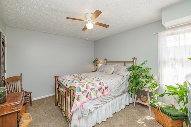 carpeted bedroom with baseboards, a textured ceiling, and ceiling fan