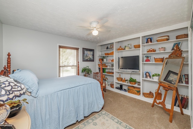 carpeted bedroom with ceiling fan and a textured ceiling