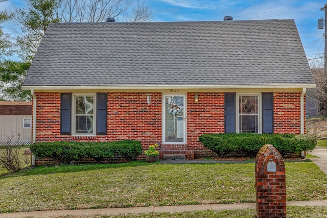 view of front of home featuring brick siding and a front lawn