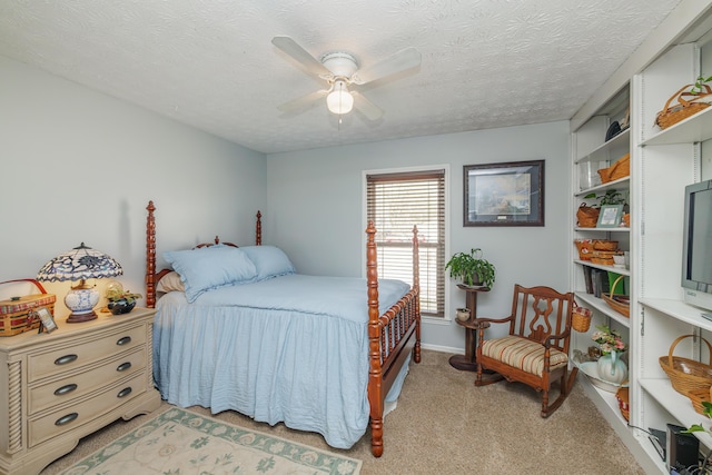 bedroom featuring ceiling fan, light colored carpet, baseboards, and a textured ceiling