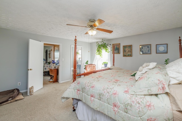 carpeted bedroom featuring baseboards, a textured ceiling, and ceiling fan