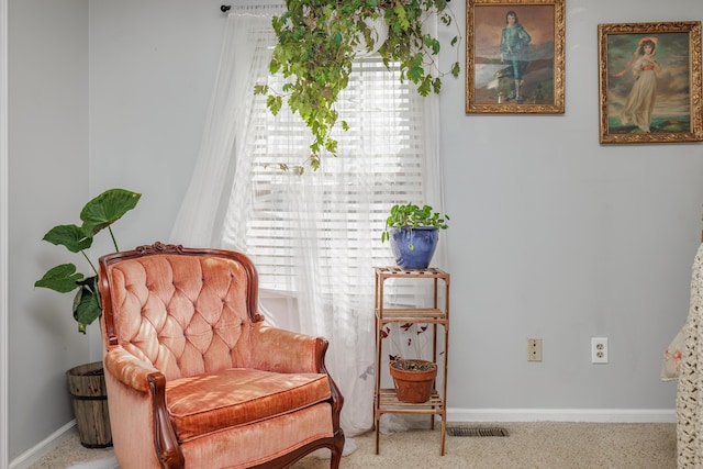 living area with visible vents and baseboards