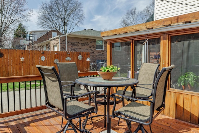 wooden terrace featuring outdoor dining area and fence