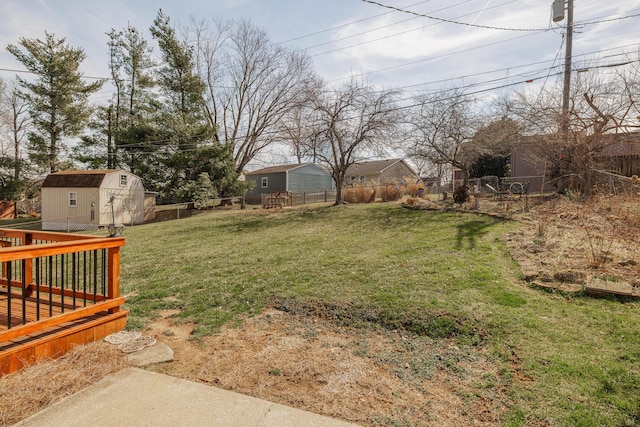 view of yard featuring a fenced backyard, a shed, and an outdoor structure