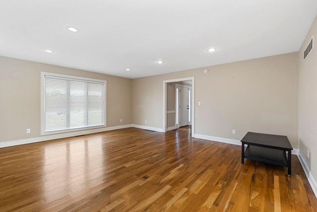 unfurnished room with recessed lighting, visible vents, baseboards, and wood finished floors