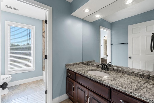 bathroom featuring visible vents, a healthy amount of sunlight, vanity, and baseboards