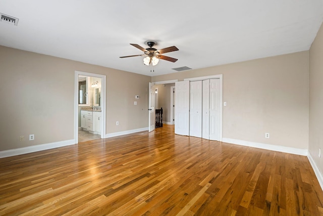 unfurnished bedroom featuring visible vents, light wood-type flooring, and baseboards