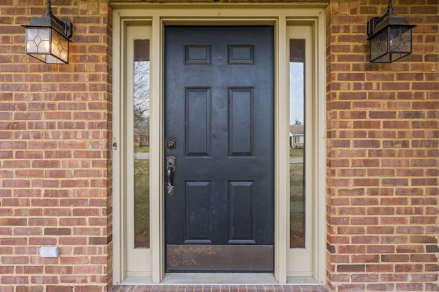 entrance to property with brick siding