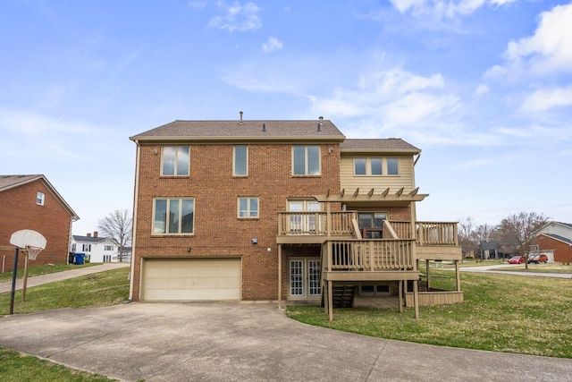 rear view of house featuring brick siding, concrete driveway, a yard, an attached garage, and a pergola