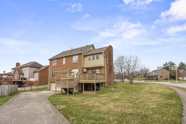 back of property with a chimney, a residential view, concrete driveway, and a garage