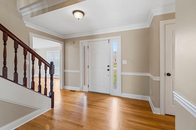 foyer entrance featuring stairway, light wood-style flooring, and baseboards