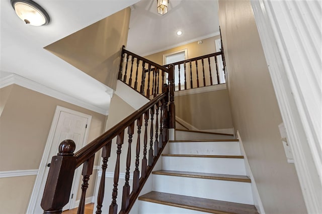 staircase with ornamental molding and recessed lighting