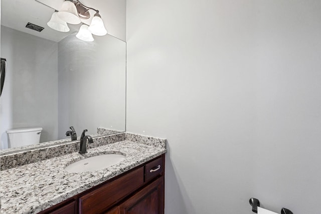half bathroom with toilet and vanity