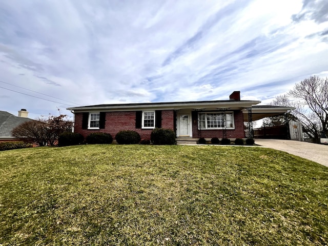 ranch-style house with an attached carport, brick siding, concrete driveway, and a front yard