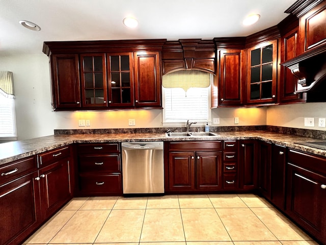 kitchen featuring a sink, dark countertops, stainless steel dishwasher, light tile patterned flooring, and dark brown cabinets