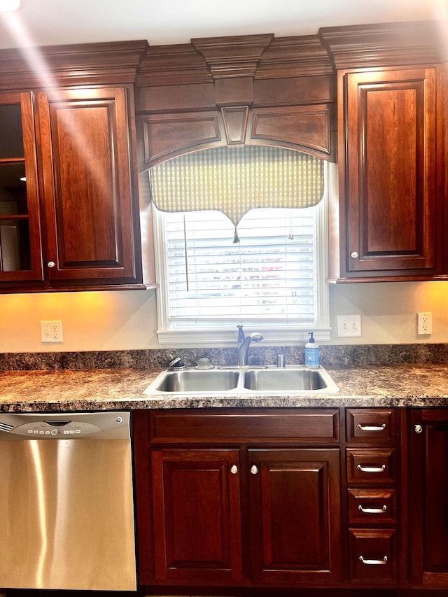 kitchen with a sink, dark countertops, dishwasher, and a wealth of natural light