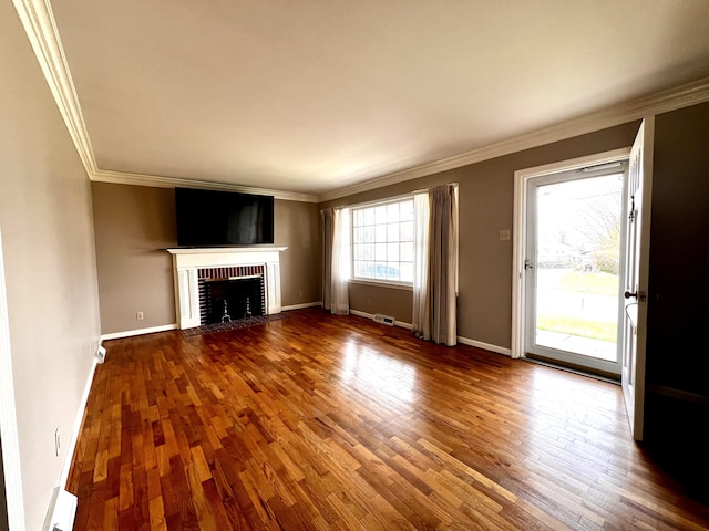 unfurnished living room with ornamental molding, a fireplace, baseboards, and wood finished floors