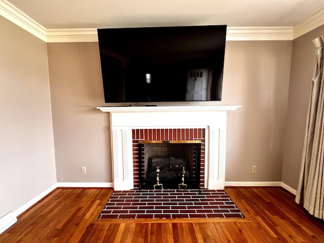 interior details with baseboards, a fireplace with flush hearth, wood finished floors, and ornamental molding