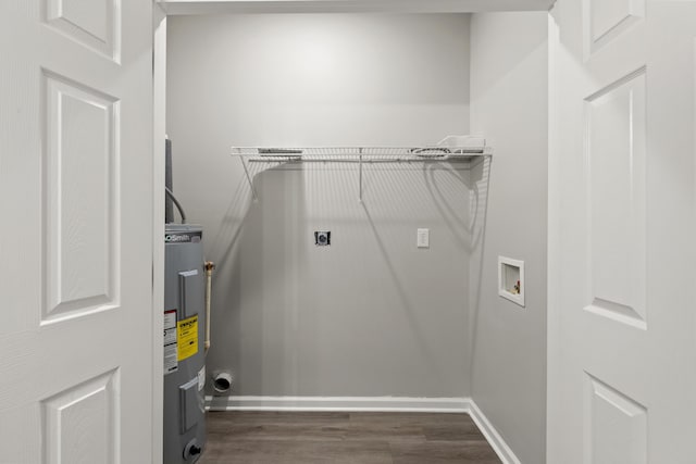 washroom with hookup for a washing machine, hookup for an electric dryer, laundry area, dark wood-type flooring, and electric water heater