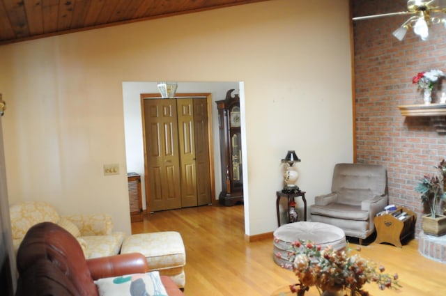 living area with wood ceiling, wood finished floors, and baseboards