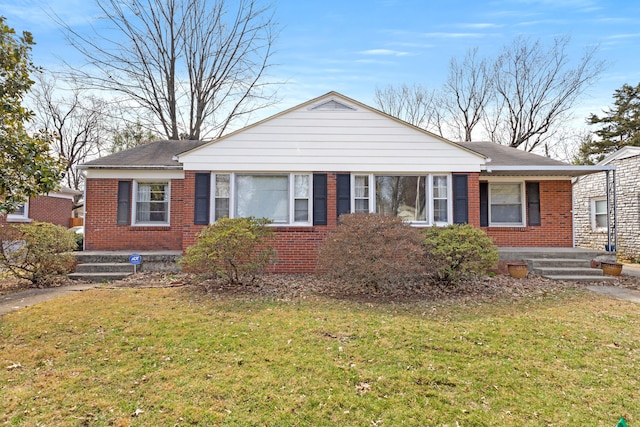 bungalow-style home featuring brick siding and a front yard